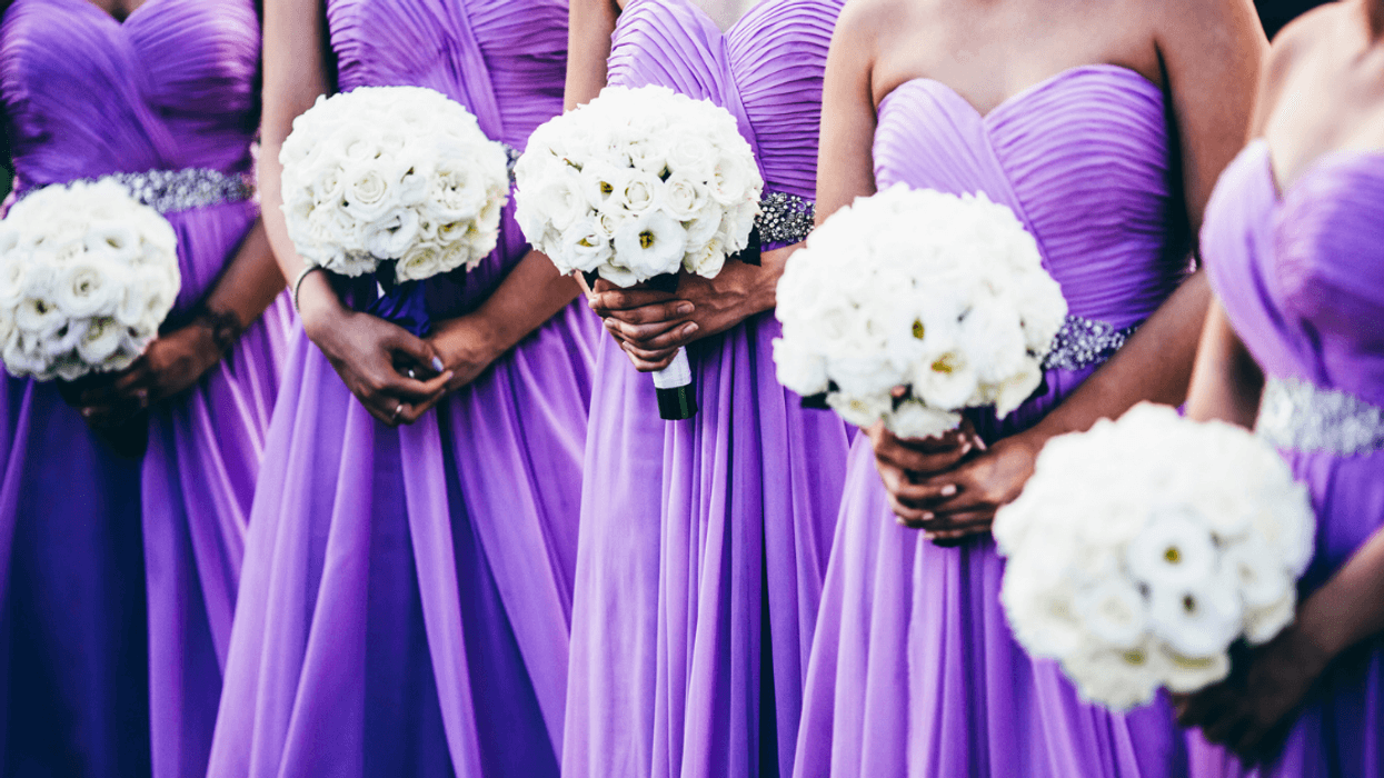 Line of bridesmaids in sleeveless dresses