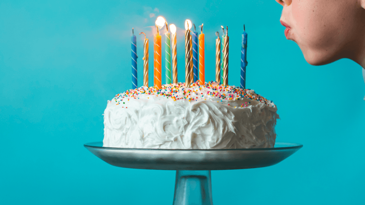 Little boy blowing out birthday candles.
