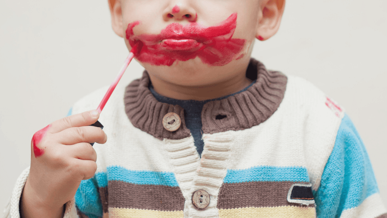 Little boy playing with makeup