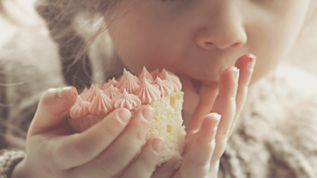 little girl eating a cupcake.