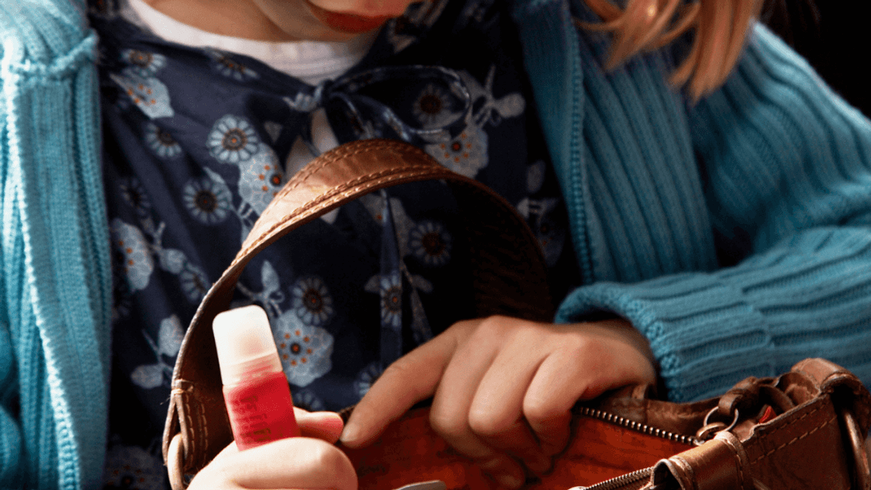 Little girl snooping through a purse