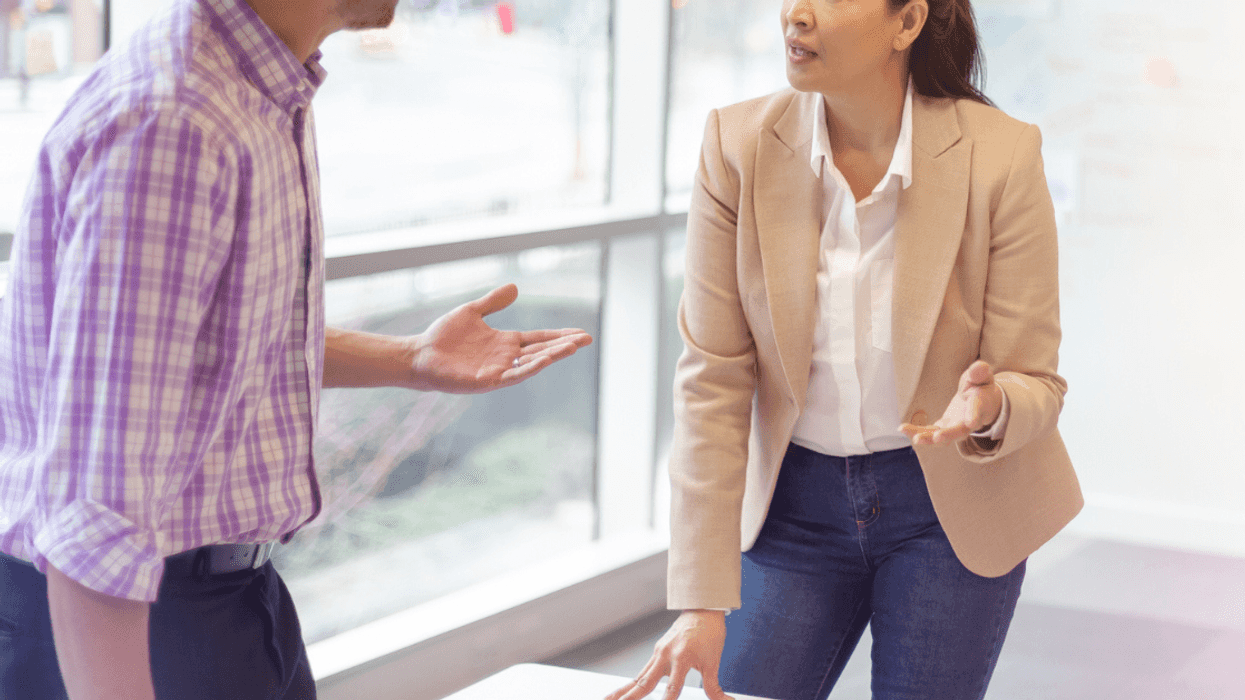 Male and female coworkers arguing in office