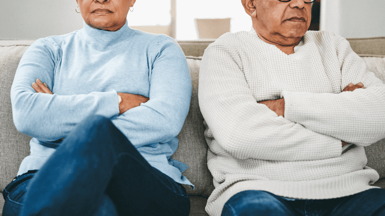 Male and female seniors sit with arms crossed