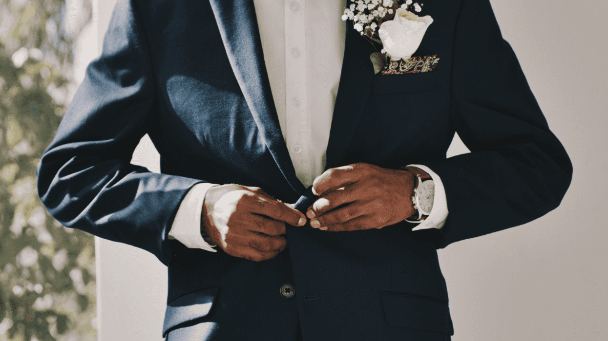 man adjusting his suit coat