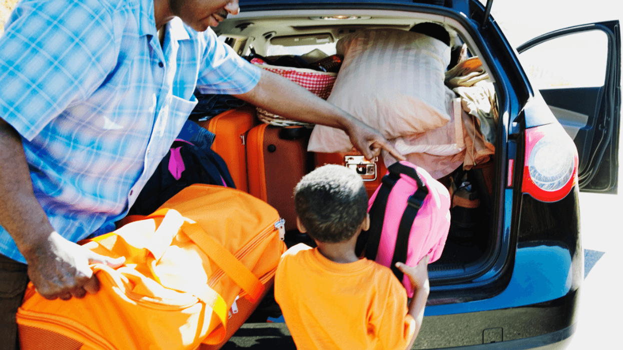 Man and child packing car for vacation