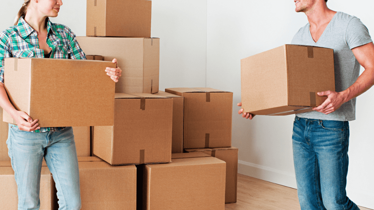 Man and woman bringing in moving boxes
