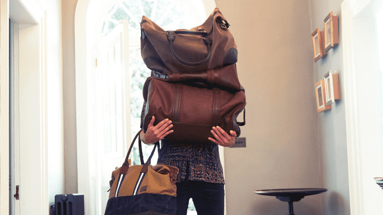 Man carrying a lot of luggage