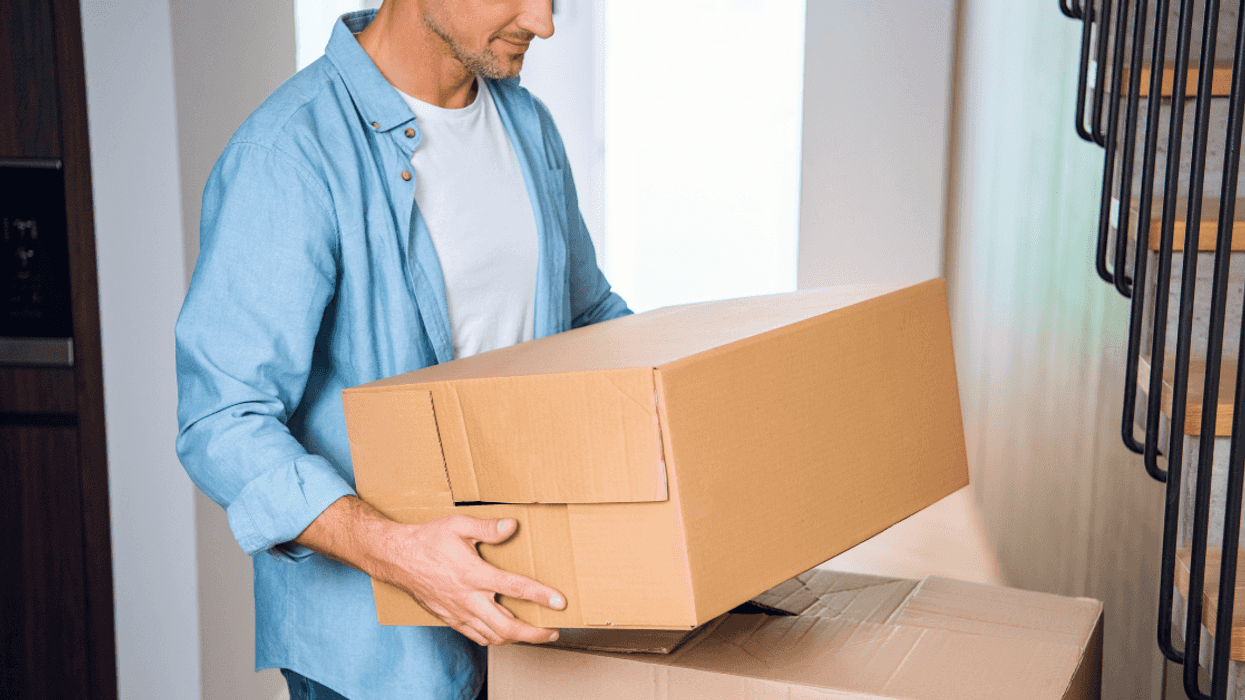 man carrying moving boxes