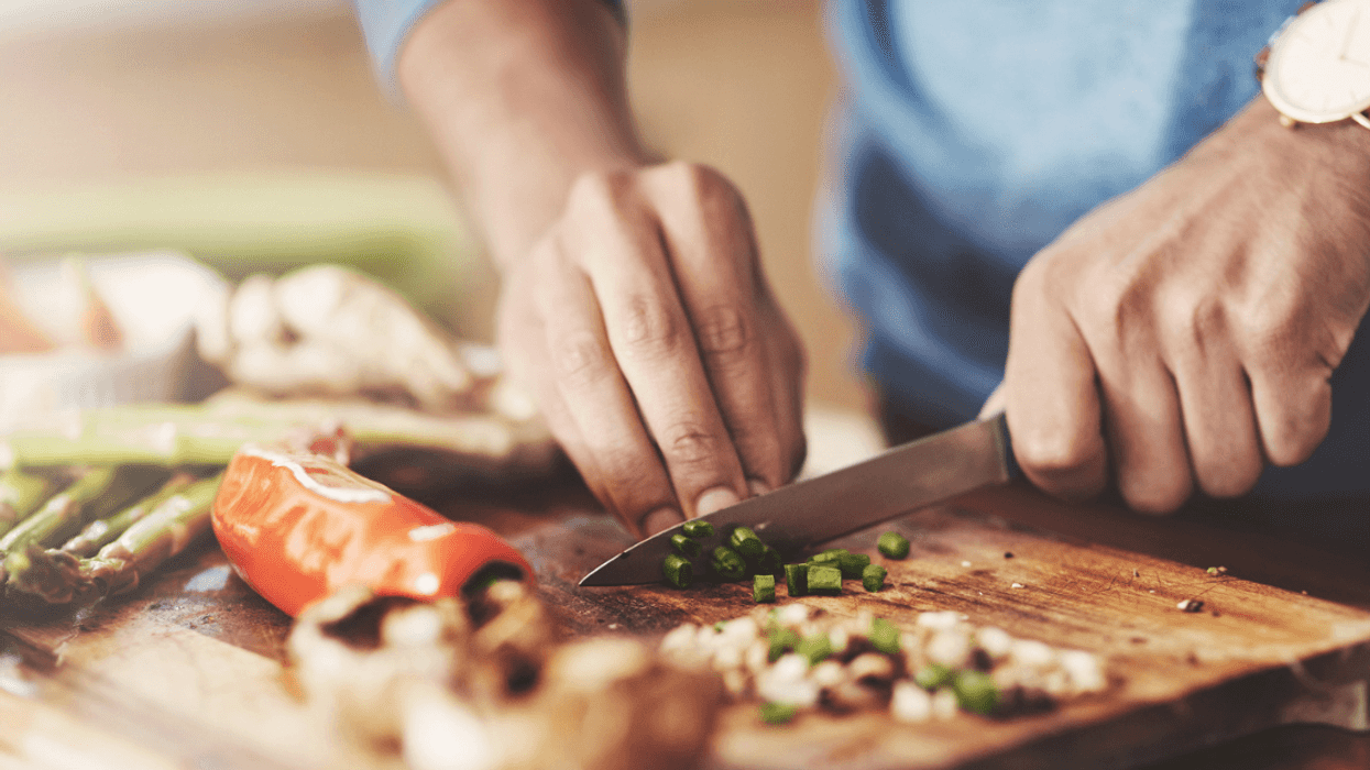 man chopping ingredients while cooking
