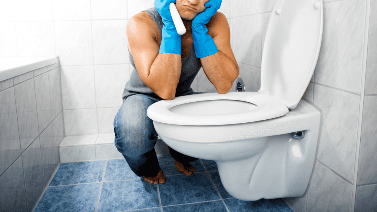 man cleaning the toilet