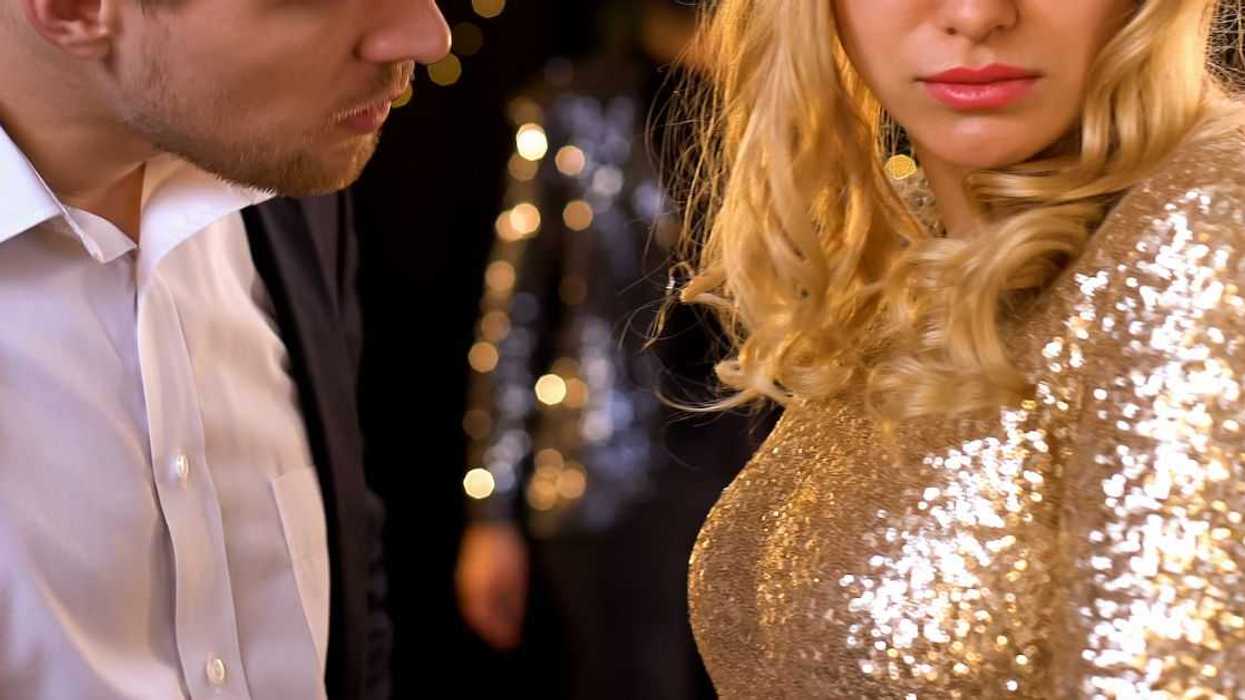 Man confronting woman at party