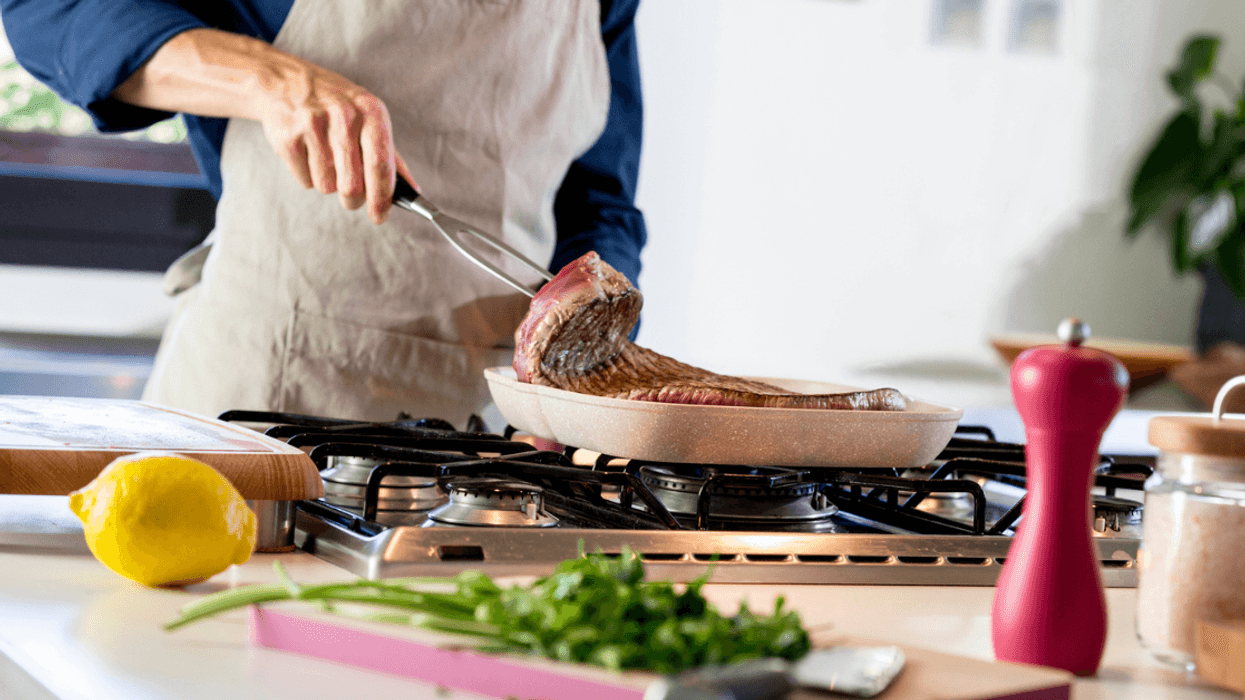 Man cooking steak.