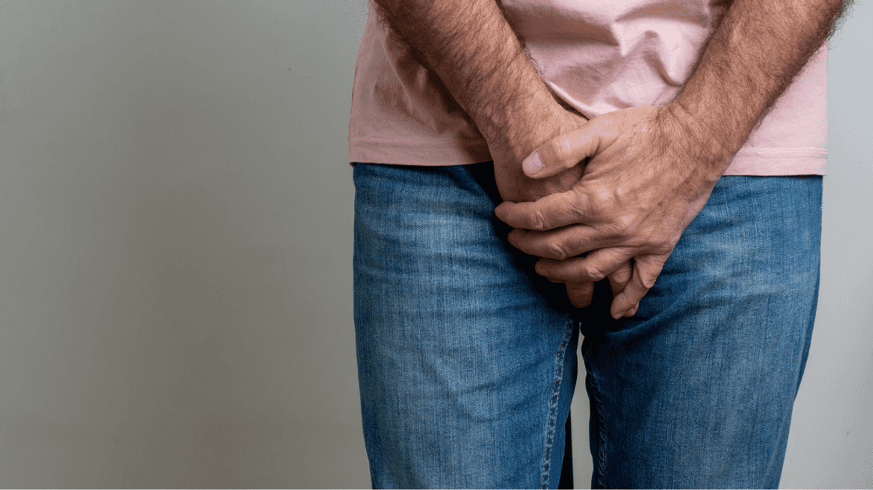 Man covering his crotch