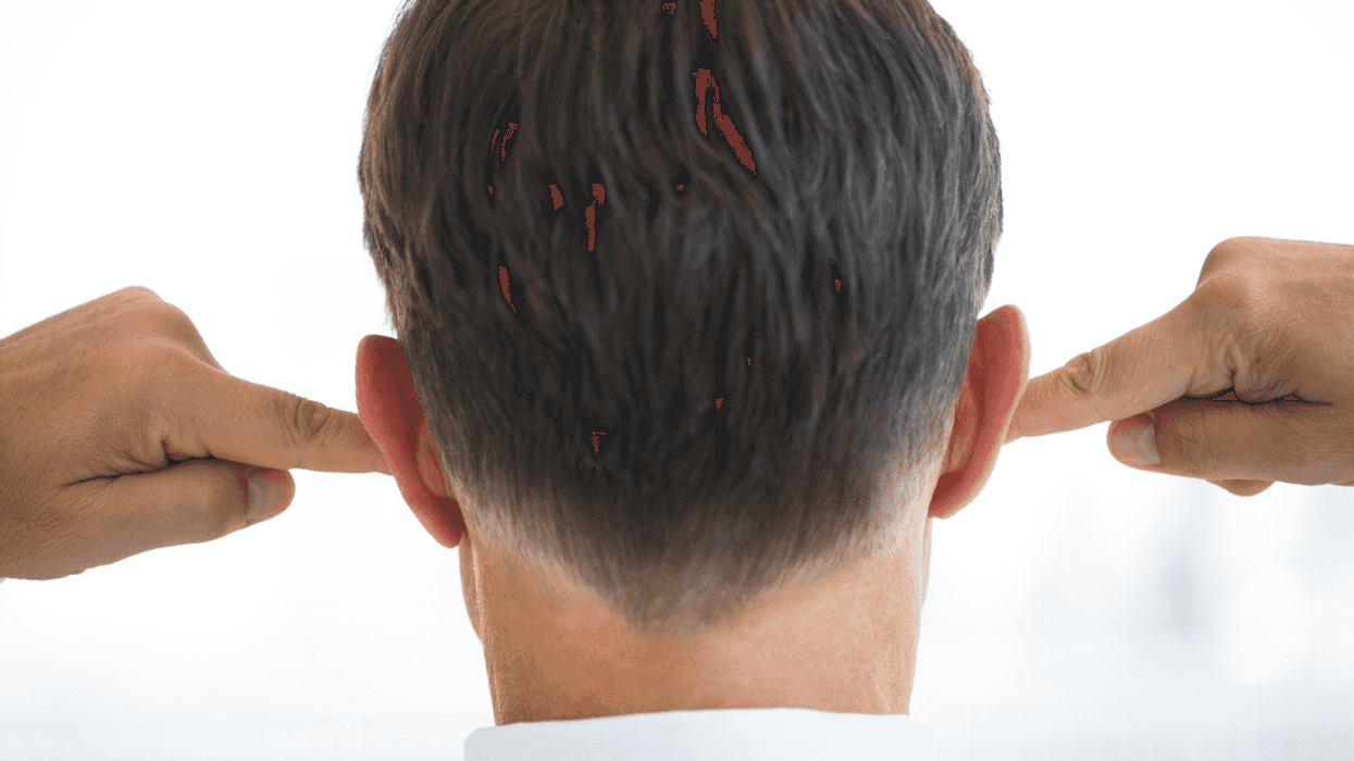 Man covering his ears