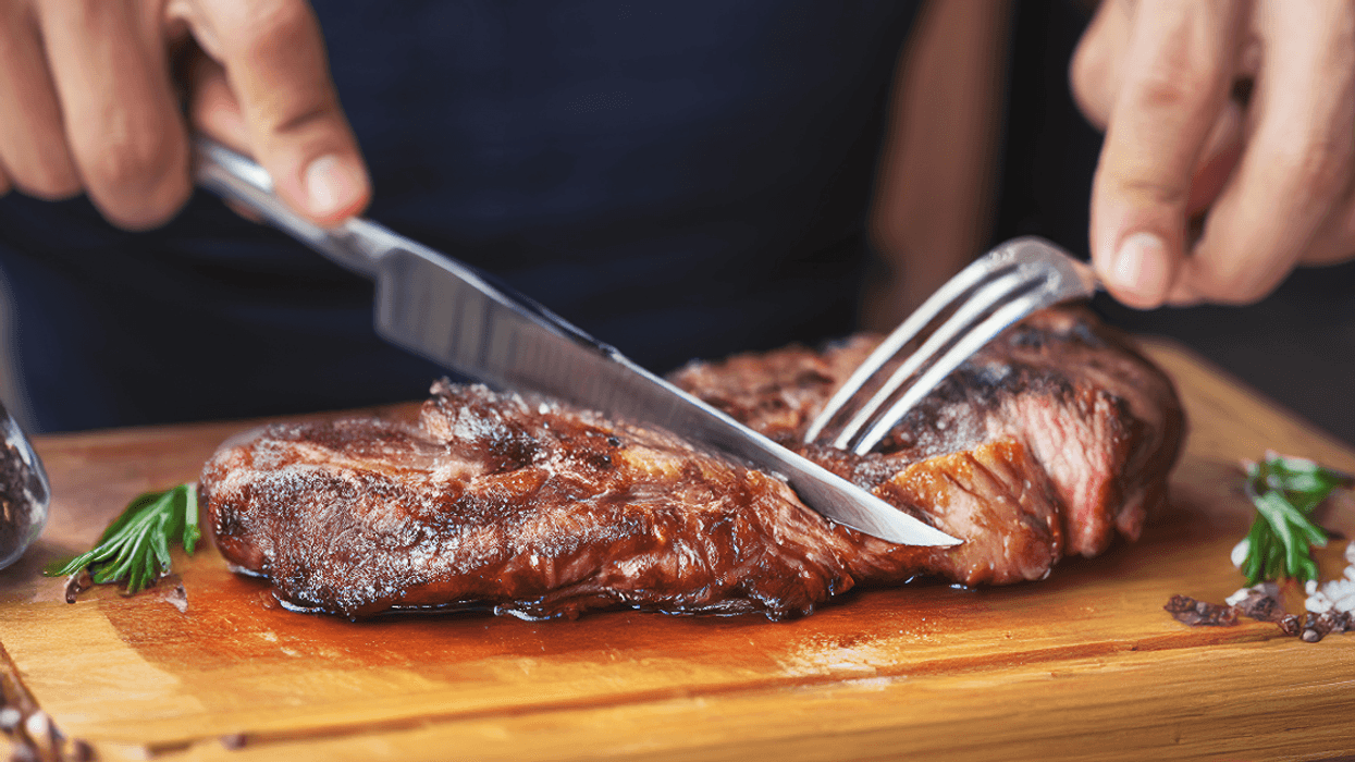 man cutting a steak