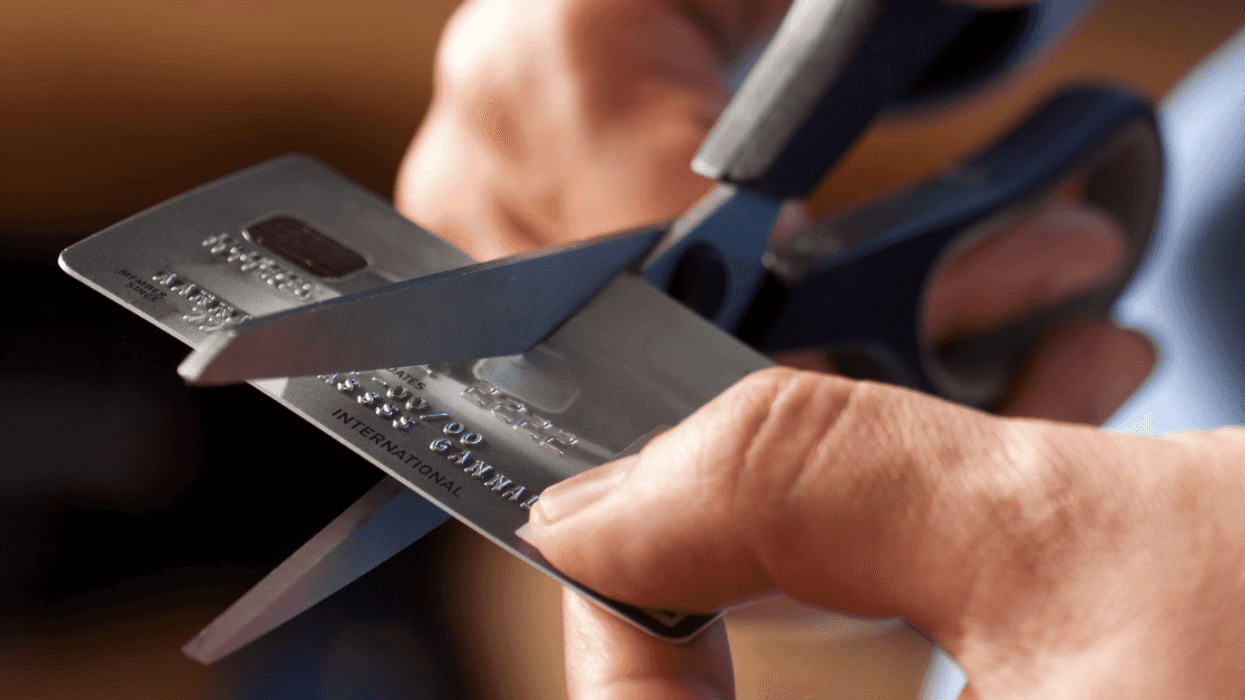 Man cutting up a credit card