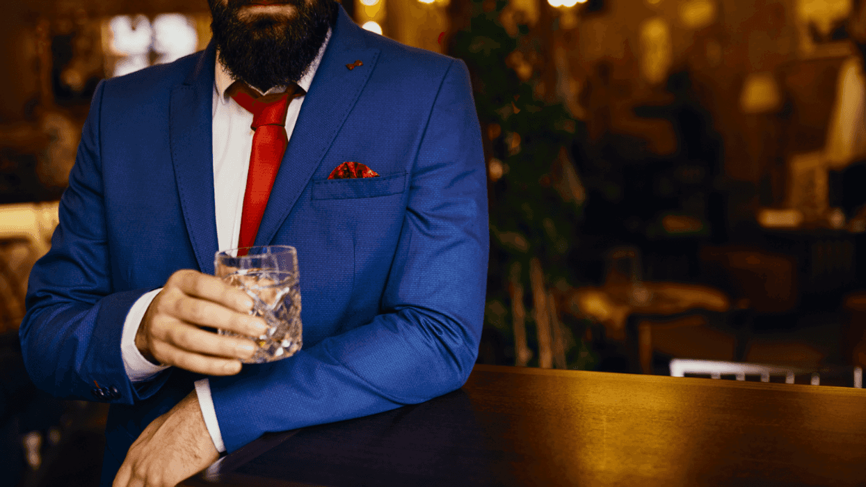 Man drinking in suit