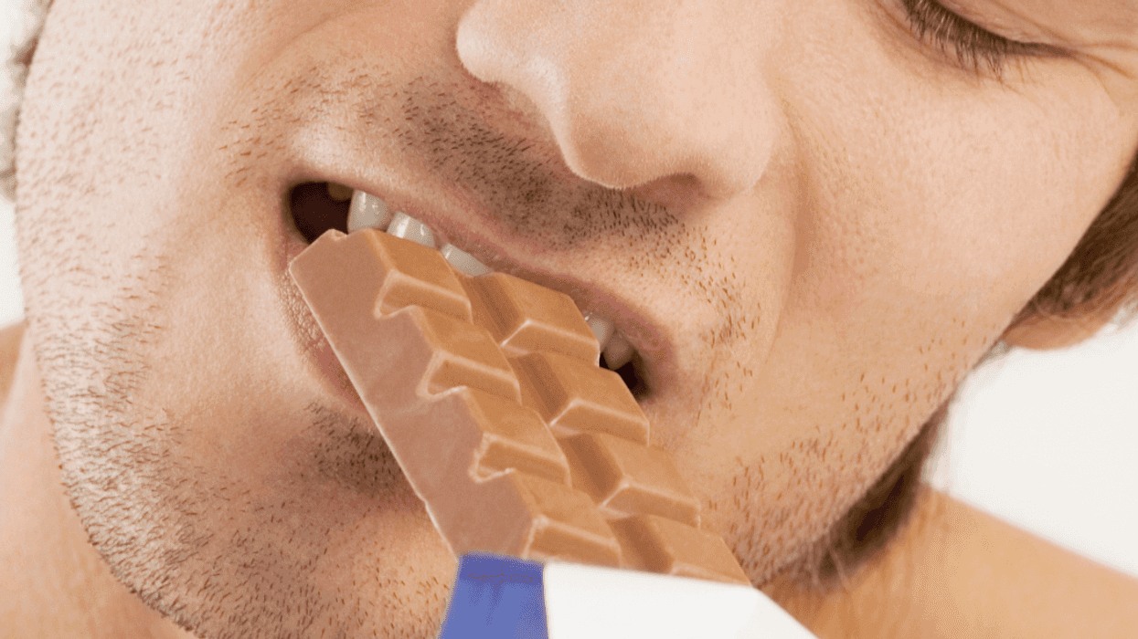 Man eating candy bar