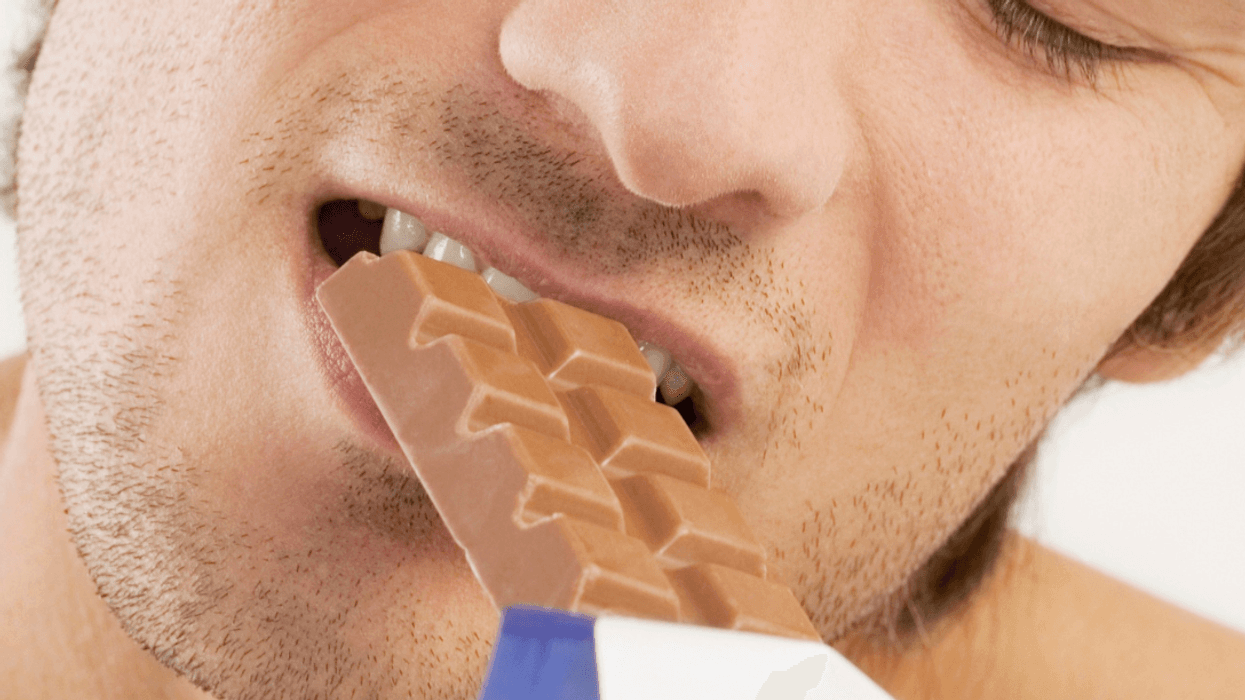 Man eating candy bar