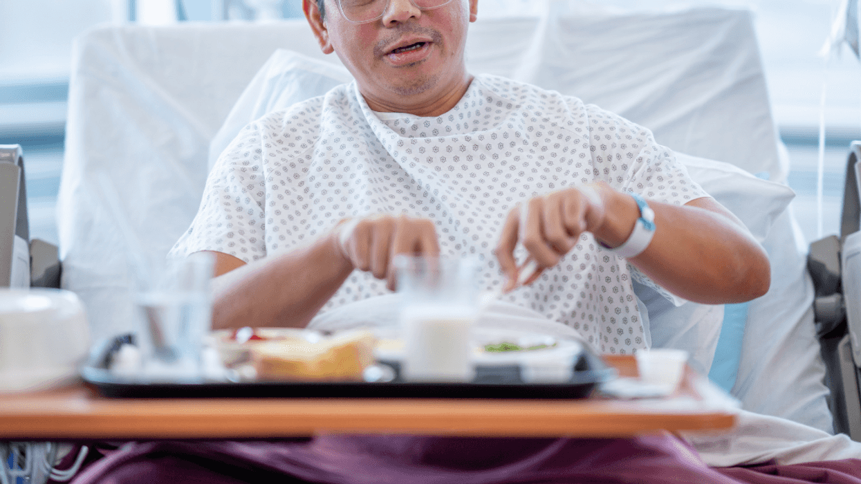 man eating hospital food