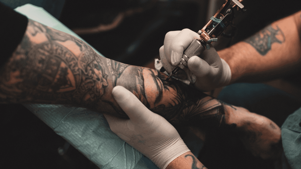 Man getting a tattoo on his arm.