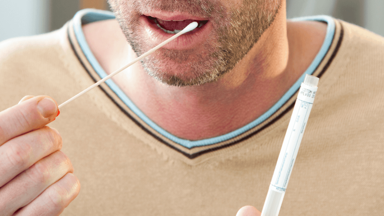 man getting DNA swab for genetic testing