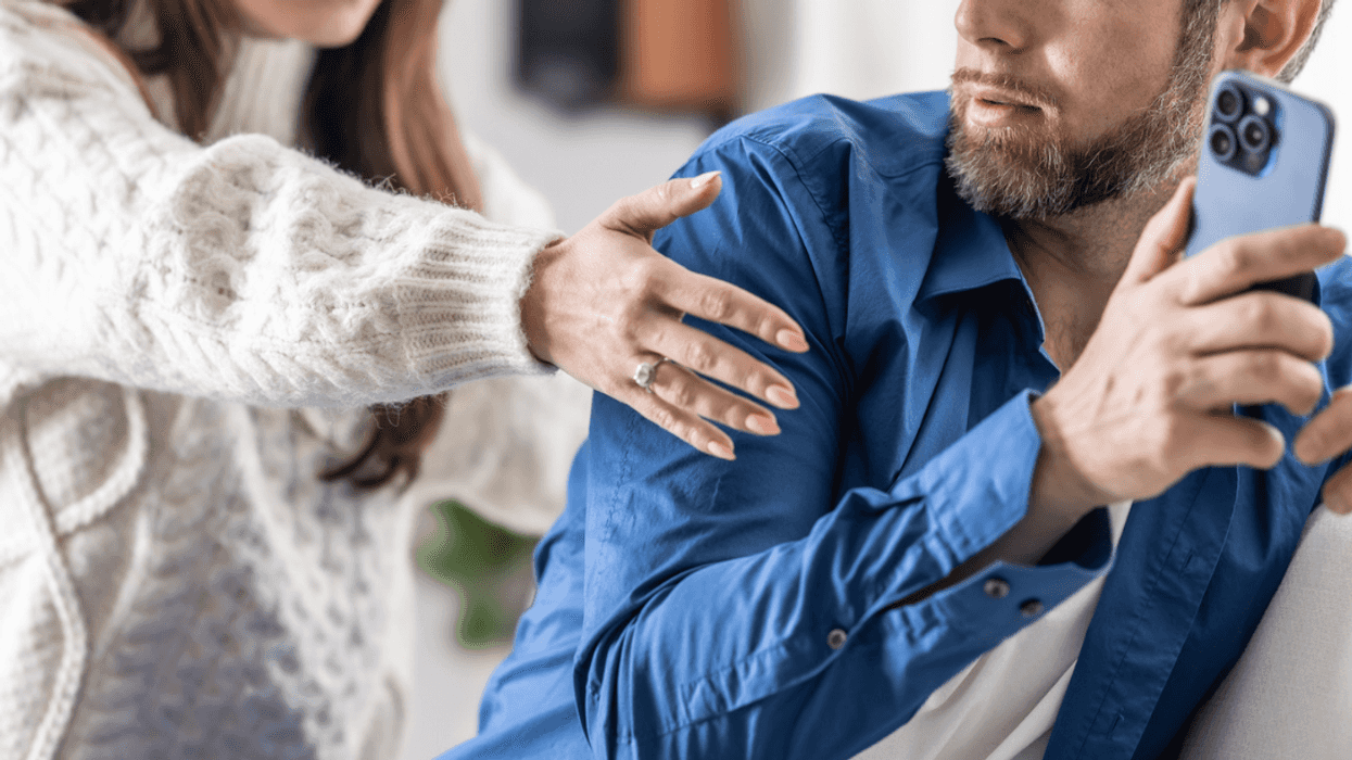 Man hiding his phone from his wife