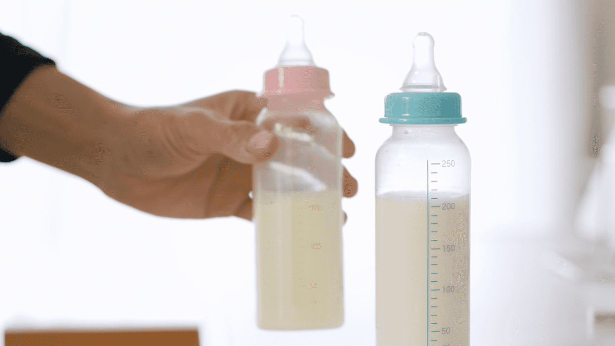 Man holding a baby bottle