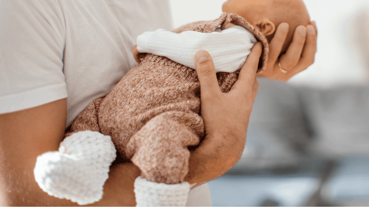 Man holding a baby in his arms.