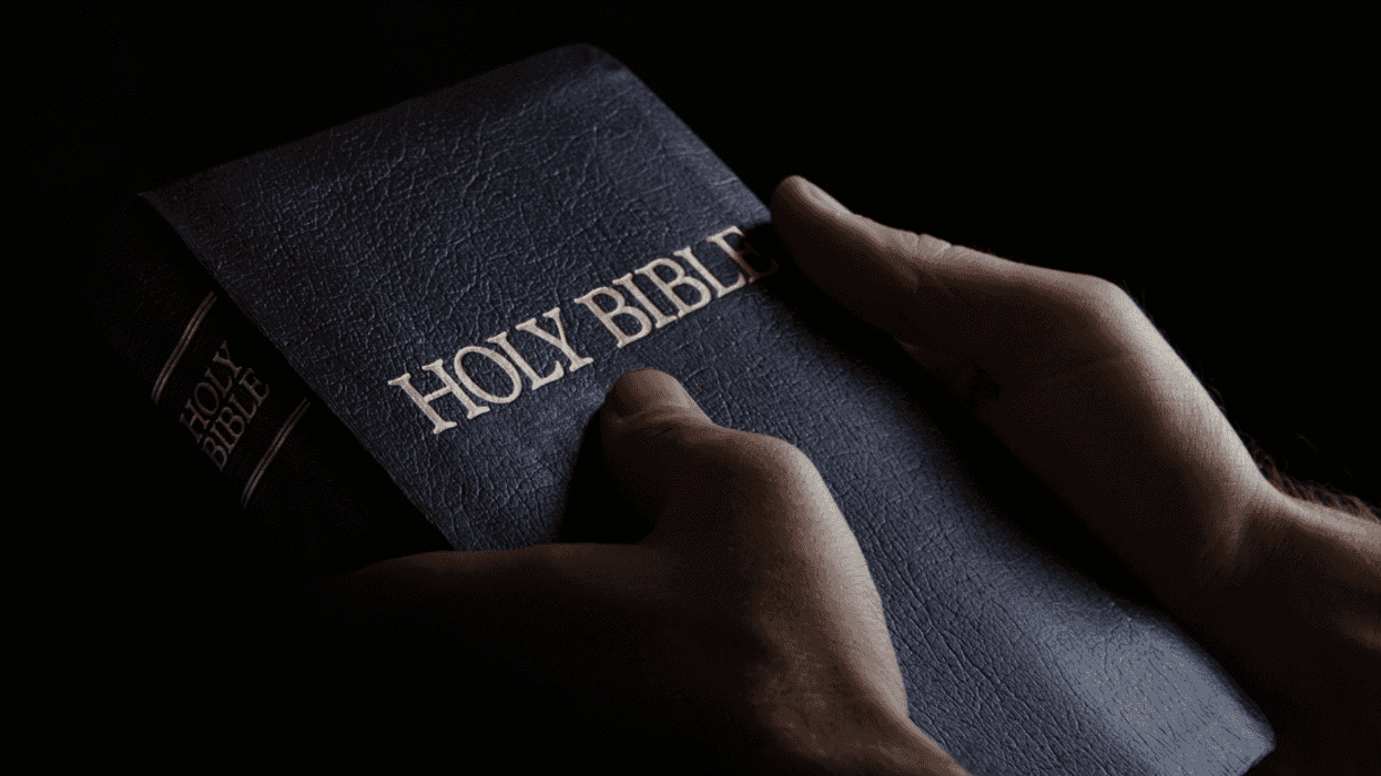 Man holding a Holy Bible