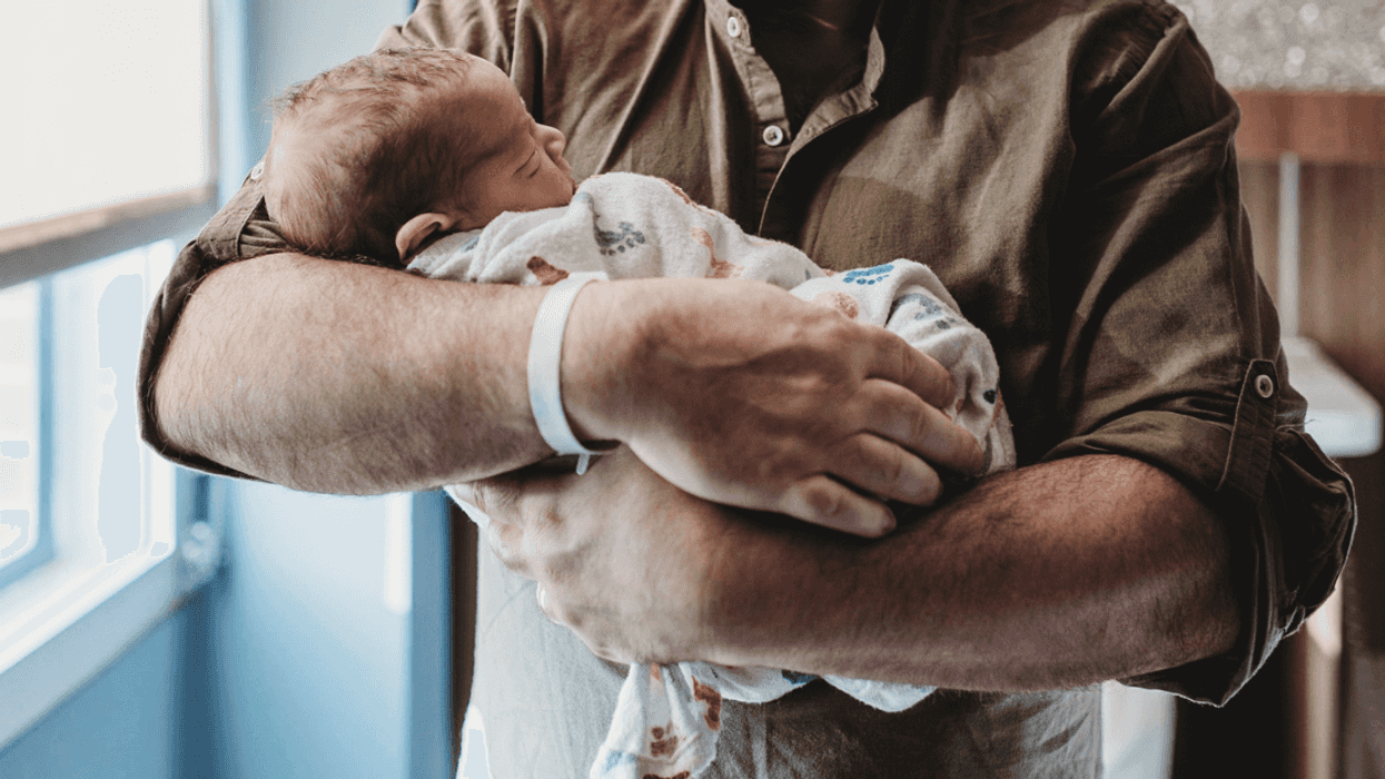 man holding newborn baby