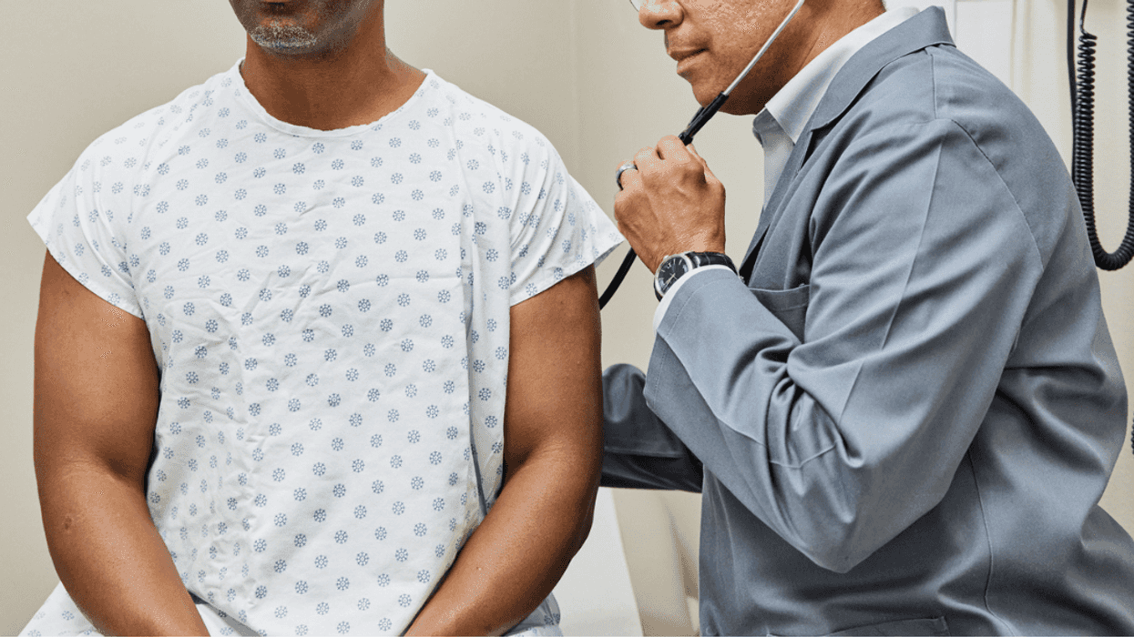 Man in hospital gown receiving health check
