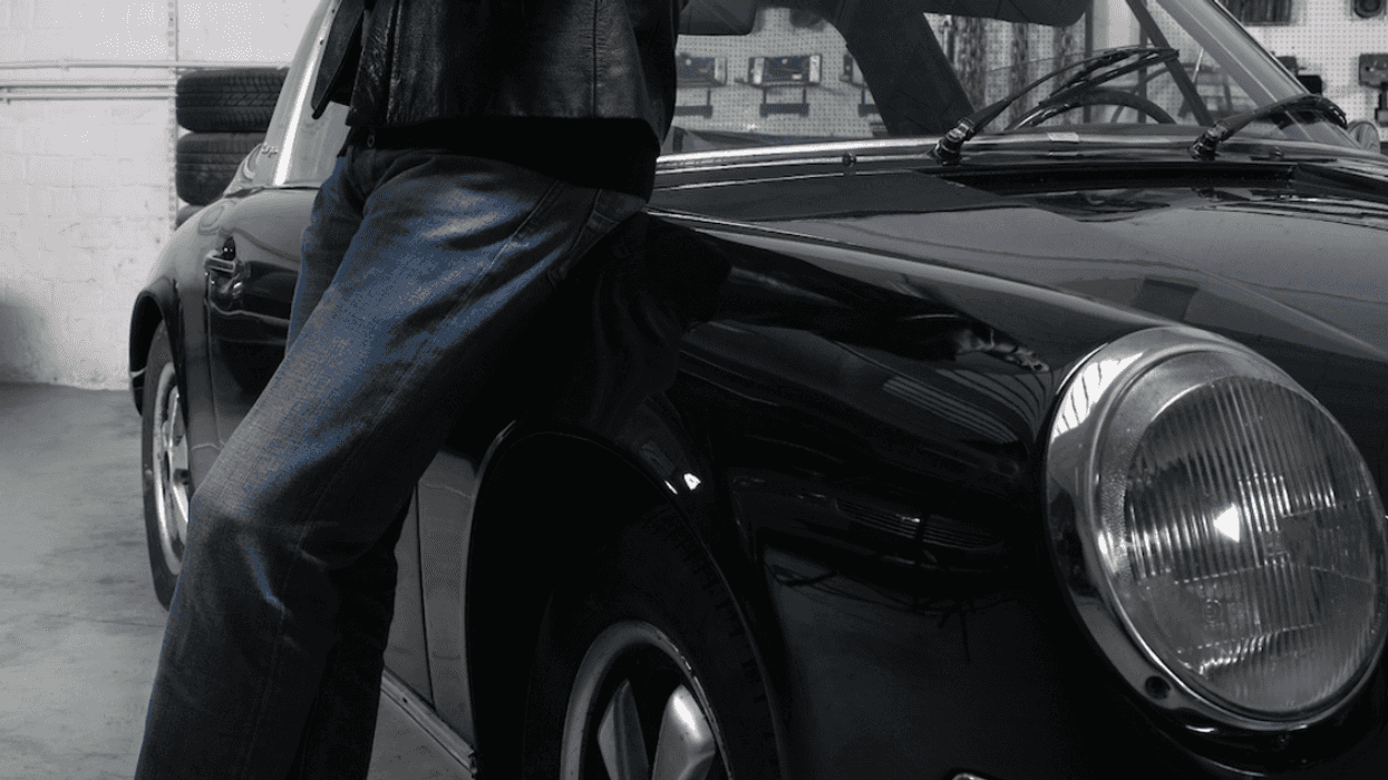 Man leaning on Porsche