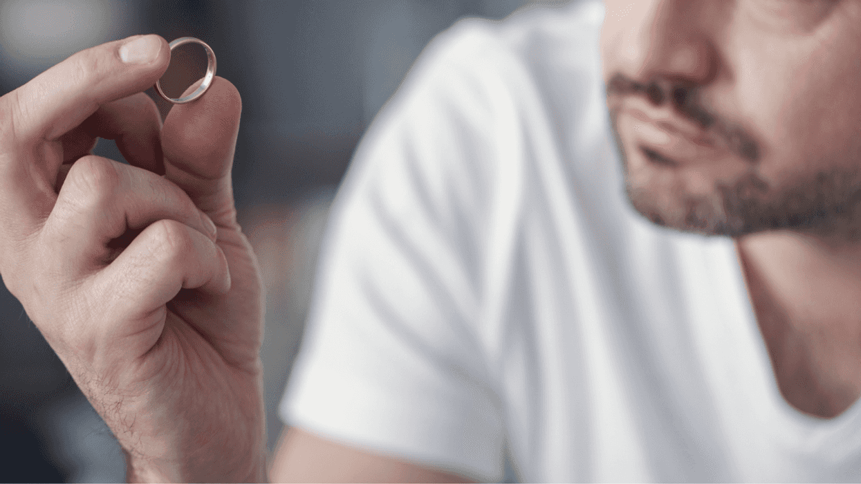 Man looking at his wedding ring