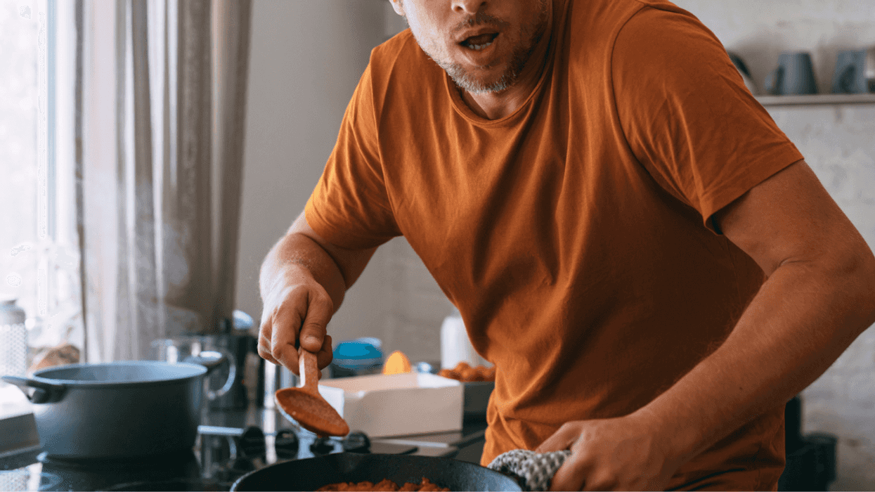 Man looking shocked while cooking