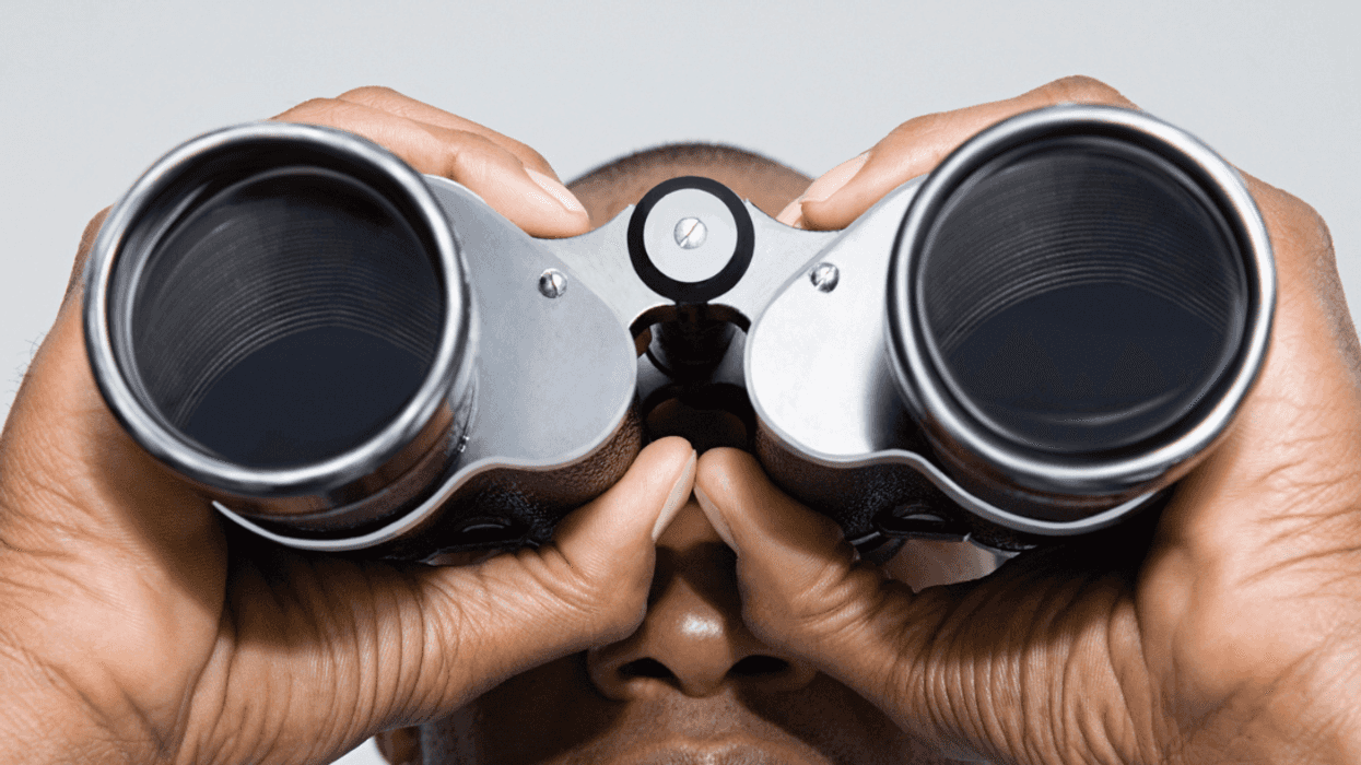 Man looking through binoculars