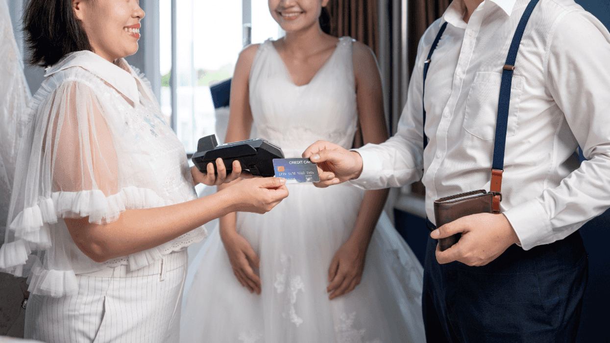 Man paying for wedding dress
