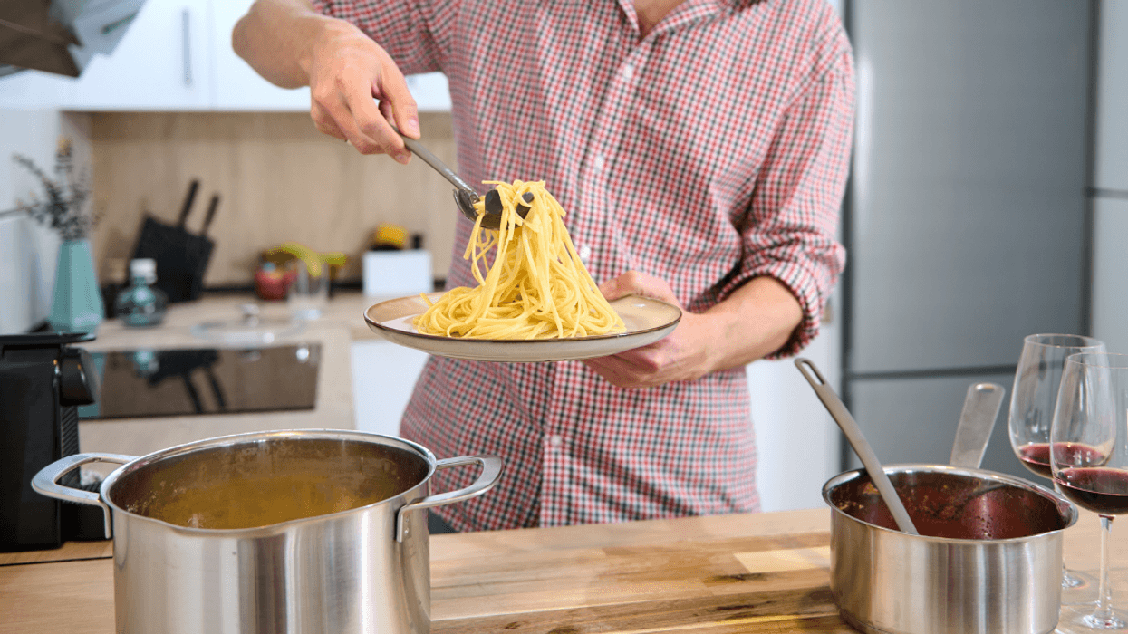 man plating food in kitchen