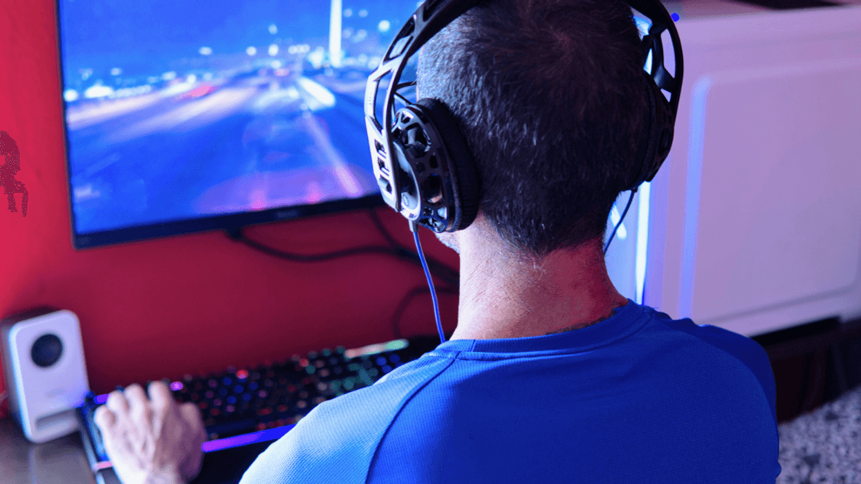 man playing games on desktop computer