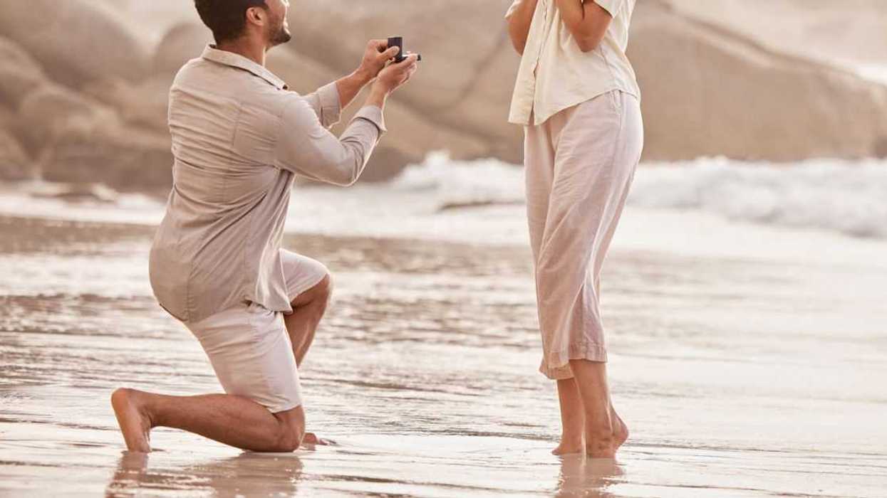 Man proposing to woman on beach