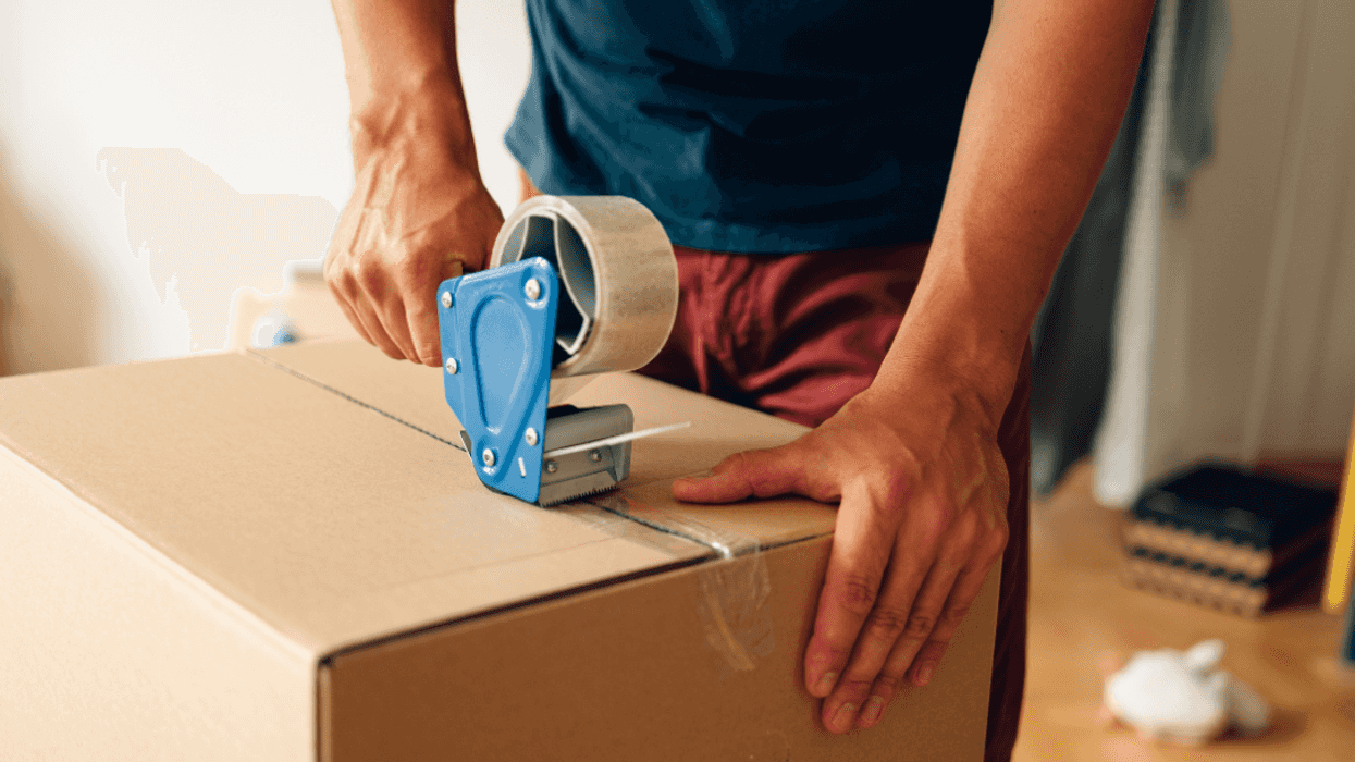 man sealing a cardboard box