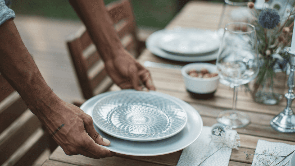Man setting the dinner table.