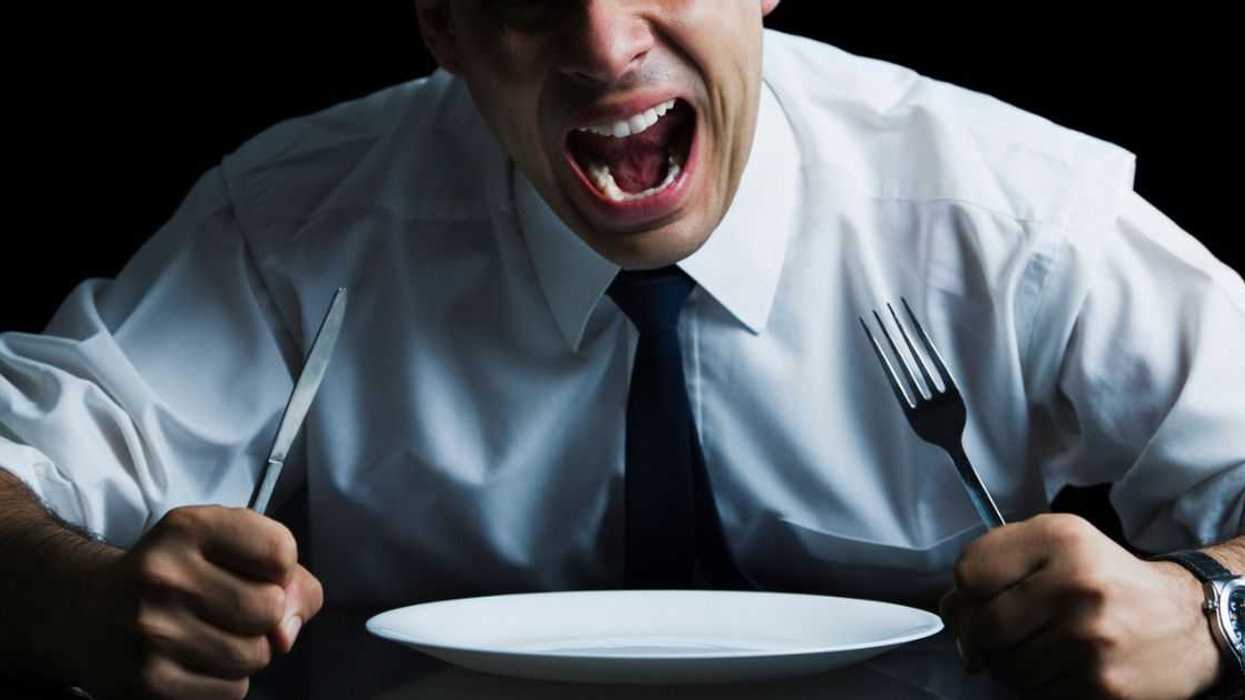 Man sitting at a dining table and shouting