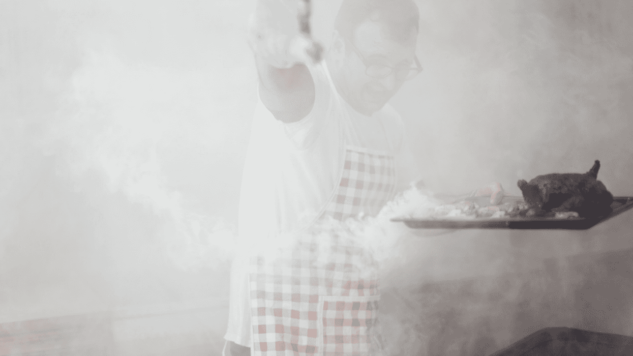 man smoking meat