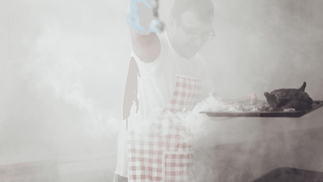 man smoking meat