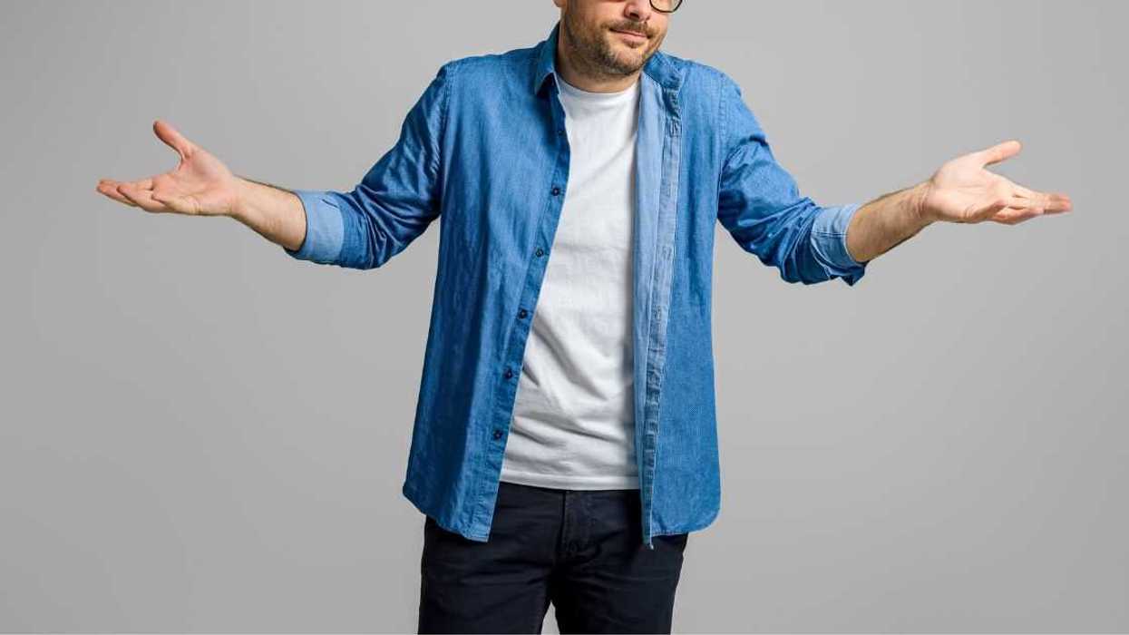 Man spreading hands and shrugging shoulders