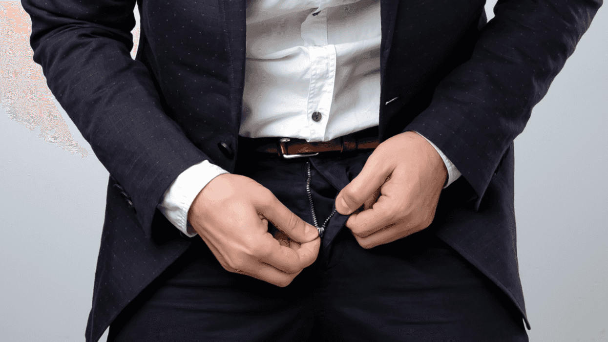 Man struggling with his zipper