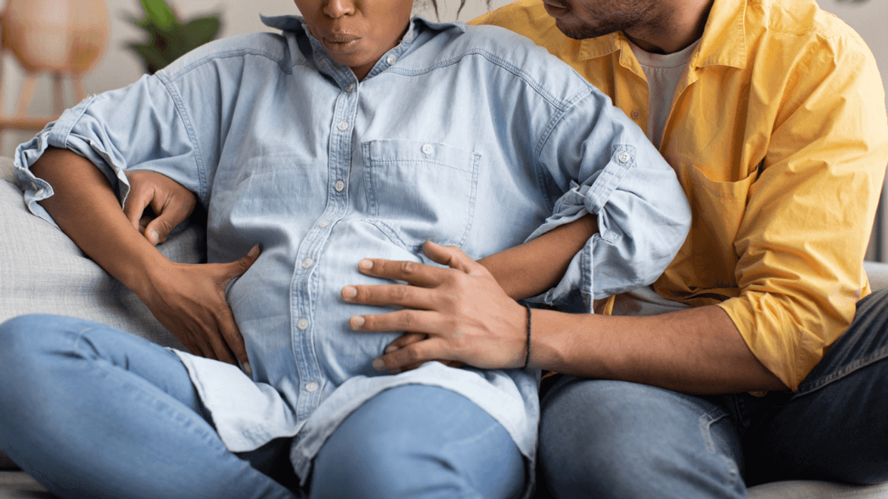 Man supporting pregnant wife