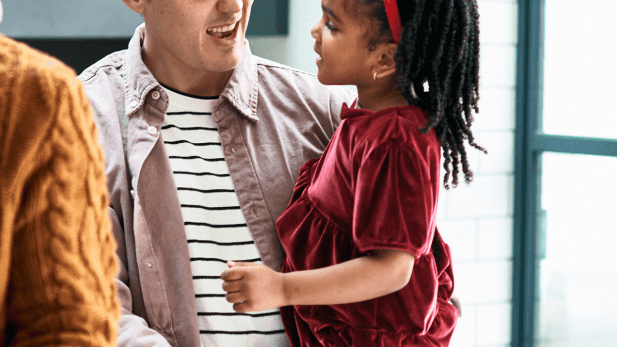 Man talking to his cousin at a family Christmas party