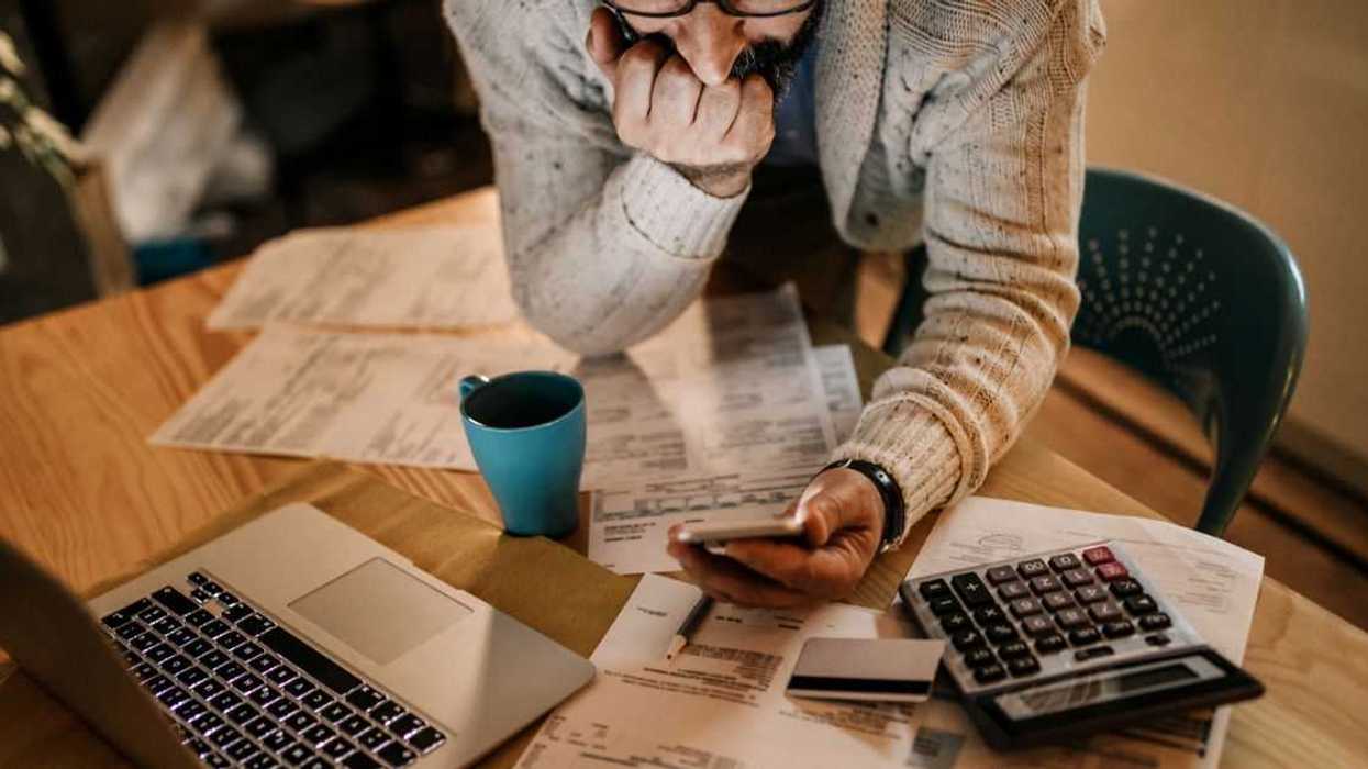 Man using phone to see price predictions.